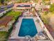 Aerial of backyard with a sparkling pool, patio, fire pit, lush lawn, pergola and beautiful landscaping at 5607 E Enrose St, Mesa, AZ 85205