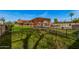 Lush green backyard with a central pergola, complete with a pool and fenced perimeter at 5607 E Enrose St, Mesa, AZ 85205