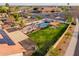 Aerial view displays a backyard with a pool, a covered pergola, and low-maintenance desert landscaping at 5607 E Enrose St, Mesa, AZ 85205