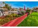 Lush backyard featuring vibrant flower beds, an outdoor seating area, and a well-maintained lawn at 5607 E Enrose St, Mesa, AZ 85205