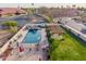 Aerial view showcases a backyard with pool, spa, pergola, and desert landscaping at 5607 E Enrose St, Mesa, AZ 85205