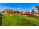 Lush backyard featuring mature landscaping and the home's solar panels at 5607 E Enrose St, Mesa, AZ 85205