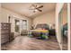 Relaxing primary bedroom featuring wood floors, sliding doors to the outside, and ample space at 5607 E Enrose St, Mesa, AZ 85205