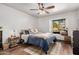 Bedroom featuring ceiling fan, wood floors, area rug, and a charming window seat at 5607 E Enrose St, Mesa, AZ 85205