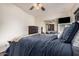 Bedroom featuring ceiling fan, dresser with TV, and closet with mirrored doors at 5607 E Enrose St, Mesa, AZ 85205