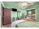 Charming bedroom with mint green walls, a mirrored closet, and a window view at 5607 E Enrose St, Mesa, AZ 85205
