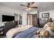 Bedroom featuring ceiling fan, dresser with TV, and closet with mirrored doors at 5607 E Enrose St, Mesa, AZ 85205