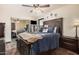 Bedroom featuring ceiling fan, dresser with TV, and closet with mirrored doors at 5607 E Enrose St, Mesa, AZ 85205