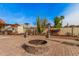 Inviting outdoor area featuring a cozy fire pit and a desert-inspired landscape at 5607 E Enrose St, Mesa, AZ 85205