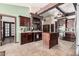 Well-equipped kitchen with custom cabinetry, tile backsplash, an island, and modern appliances at 5607 E Enrose St, Mesa, AZ 85205