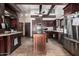 Spacious kitchen features a central island, stainless steel appliances, and dark wood cabinetry at 5607 E Enrose St, Mesa, AZ 85205