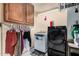 Laundry room featuring washer, dryer, and wooden cabinets for storage at 5607 E Enrose St, Mesa, AZ 85205