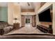 Spacious living room featuring wood accents, tile floors, and a modern entertainment center at 5607 E Enrose St, Mesa, AZ 85205