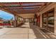 Covered patio with grill, lush greenery, and string lights for outdoor entertaining at 5607 E Enrose St, Mesa, AZ 85205