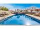 Relaxing pool featuring rock waterfall, hot tub, and plenty of room for outdoor seating at 5607 E Enrose St, Mesa, AZ 85205