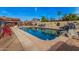 Sparkling pool area with rock waterfall feature and plenty of room for outdoor lounging at 5607 E Enrose St, Mesa, AZ 85205