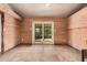 Sunroom featuring stone floors, wood paneled walls and a sliding glass door to the backyard at 5607 E Enrose St, Mesa, AZ 85205