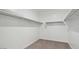 Bright walk-in closet with carpeted floors and built-in shelving at 5772 E Axle Ln, San Tan Valley, AZ 85140