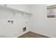 Well-lit laundry room featuring tile floor and shelving at 5772 E Axle Ln, San Tan Valley, AZ 85140
