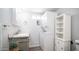 Well-lit bathroom includes vanity with lavender, in-unit washer/dryer, and shelving for convenient storage at 60 S Jacknife Dr, Apache Junction, AZ 85119