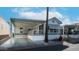 Cozy home boasts covered parking, a porch and landscaping with a palm tree at 60 S Jacknife Dr, Apache Junction, AZ 85119