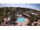 Aerial view of the community pools, tennis courts, and surrounding landscape at 6460 S Springs Pl, Chandler, AZ 85249