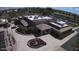 Aerial view of the community clubhouse with manicured landscaping and circular driveway at 6460 S Springs Pl, Chandler, AZ 85249