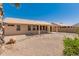 The large backyard boasts desert landscaping and covered patio at 6460 S Springs Pl, Chandler, AZ 85249