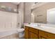 Bright bathroom featuring oak cabinets, a shower and tub, and tile flooring at 6460 S Springs Pl, Chandler, AZ 85249