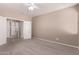 Spacious bedroom with carpet and a bathroom connected through white doors at 6460 S Springs Pl, Chandler, AZ 85249