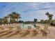 Inviting community pool surrounded by lounge chairs and lush desert landscaping at 6460 S Springs Pl, Chandler, AZ 85249