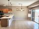 The dining area has a sliding door to the outside and three windows bringing in a lot of light at 6460 S Springs Pl, Chandler, AZ 85249