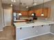 Well-lit kitchen featuring a large island, stainless steel appliances, and plenty of counter space at 6460 S Springs Pl, Chandler, AZ 85249