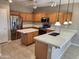 Spacious kitchen features wood cabinetry, quartz countertops, stainless steel appliances and kitchen island at 6460 S Springs Pl, Chandler, AZ 85249