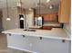 A spacious kitchen island with seating, stainless appliances, and tons of cabinetry at 6460 S Springs Pl, Chandler, AZ 85249