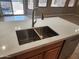 Kitchen island features a stainless steel faucet and double basin sink with white countertops at 6460 S Springs Pl, Chandler, AZ 85249