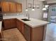 Open kitchen with an island, pendant lights, and stainless steel appliances at 6460 S Springs Pl, Chandler, AZ 85249