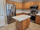 A great kitchen offers stainless steel appliances, a kitchen island, and lots of cabinet space at 6460 S Springs Pl, Chandler, AZ 85249