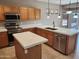 The kitchen features stainless steel appliances, a spacious countertop, and plenty of cabinet space at 6460 S Springs Pl, Chandler, AZ 85249