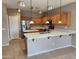 This open kitchen features stainless steel appliances, a center island, and lots of cabinets at 6460 S Springs Pl, Chandler, AZ 85249