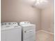 Laundry room has tile flooring and white washer and dryer at 6460 S Springs Pl, Chandler, AZ 85249