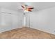 Bright bedroom with a ceiling fan, tile floors, and a closet for ample storage space at 6707 N 42Nd Ave, Phoenix, AZ 85019