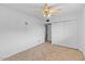 Spacious bedroom features tile flooring, a ceiling fan, and a closet providing storage at 6707 N 42Nd Ave, Phoenix, AZ 85019