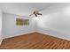 Bright bedroom features wood floors, a ceiling fan, and a window letting in natural light at 6707 N 42Nd Ave, Phoenix, AZ 85019