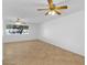 Spacious bedroom features tile floors, two ceiling fans, and a large window at 6707 N 42Nd Ave, Phoenix, AZ 85019