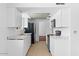 Modern kitchen with white cabinets, a stainless steel sink, and tile floors at 6707 N 42Nd Ave, Phoenix, AZ 85019