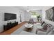 Comfortable living room showcasing a plush sofa, modern entertainment center, and contemporary design elements for relaxed living at 6707 N 42Nd Ave, Phoenix, AZ 85019