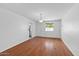 Bright living room with hardwood floors, white walls, and a window providing natural light at 6707 N 42Nd Ave, Phoenix, AZ 85019
