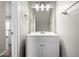 Bright bathroom featuring a white vanity, large mirror, and modern lighting fixtures at 6713 S Jentilly Ln, Tempe, AZ 85283