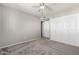 Bedroom featuring plush carpet, a ceiling fan, neutral colored walls and large closets at 6713 S Jentilly Ln, Tempe, AZ 85283